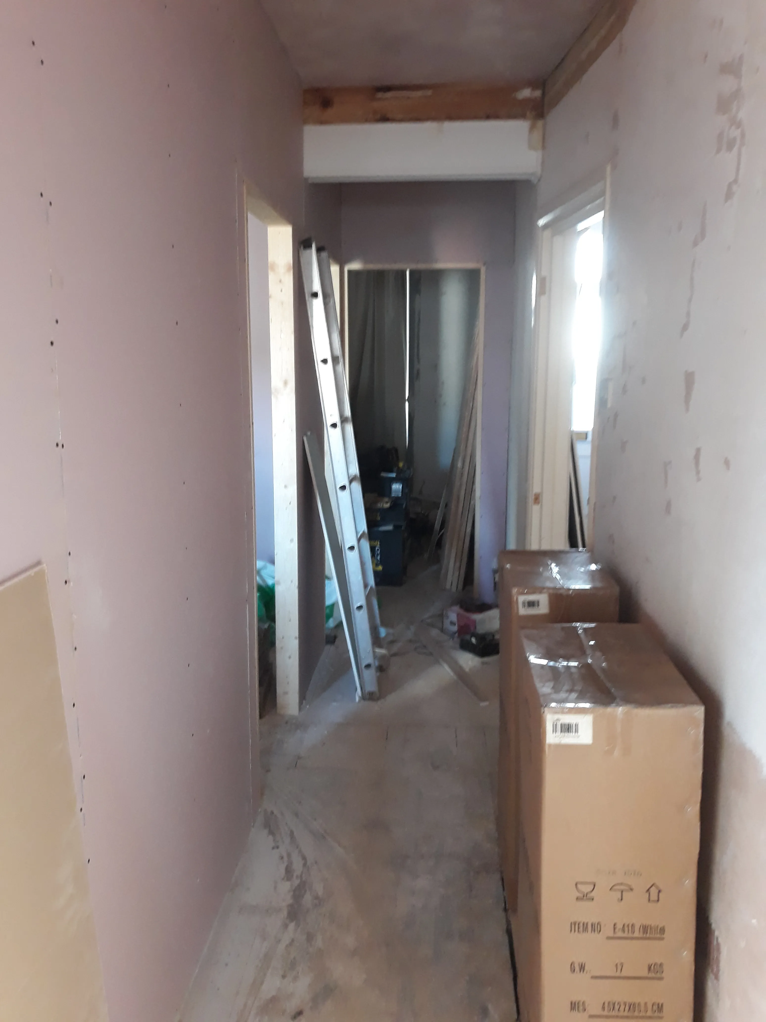 HMO conversion hallway during refurbishment with materials on site
